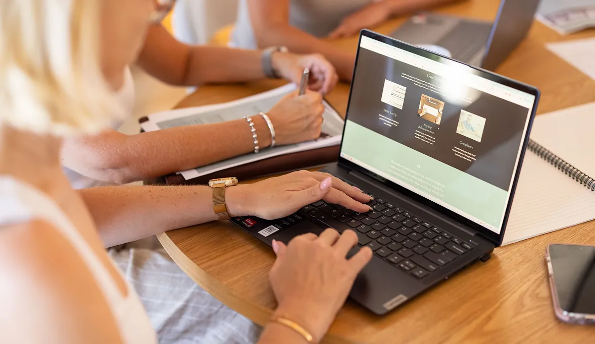 Andromedae team members reviewing the Andromedae website on a laptop